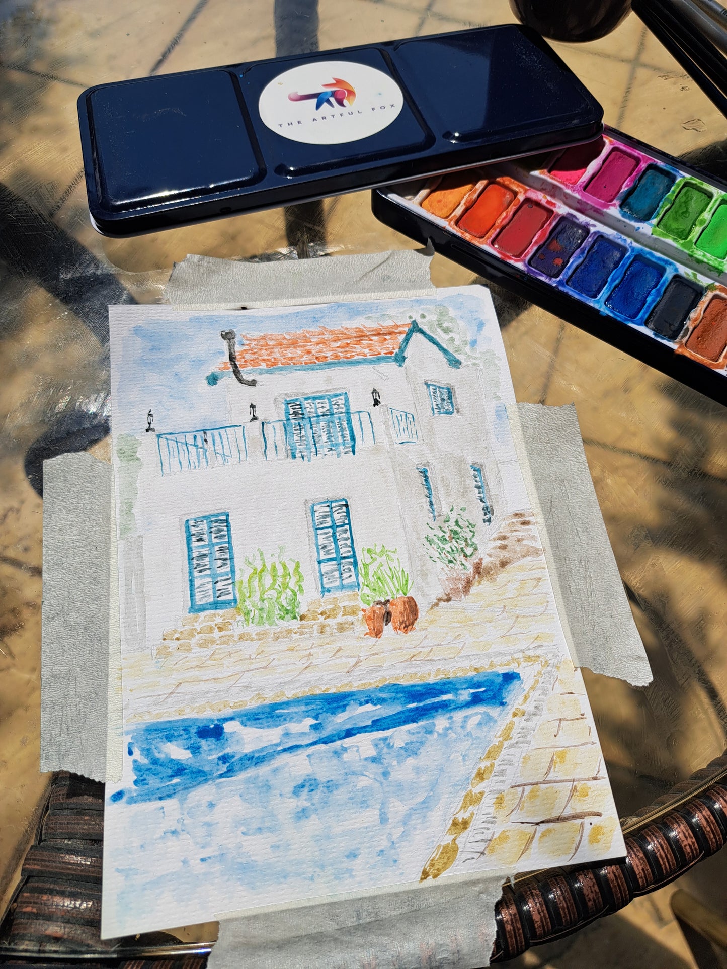 Children's and beginner's watercolour paint set by The Artful Fox. With 24 vibrant colours, in attractive tin with palette lid. Includes paintbrush! The perfect educational gift for the hobby artist in your life