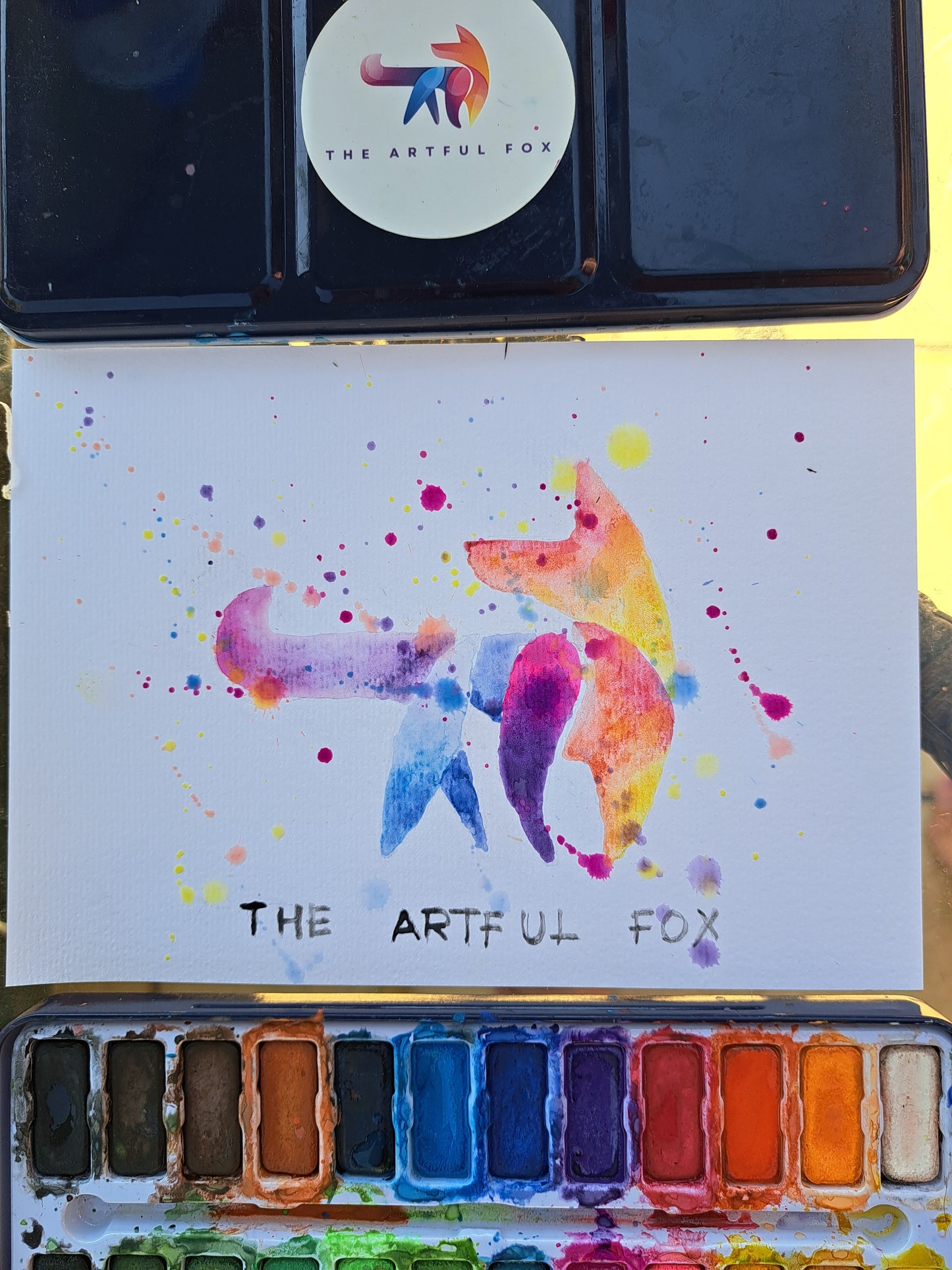 Children's and beginner's watercolour paint set by The Artful Fox. With 24 vibrant colours, in attractive tin with palette lid. Includes paintbrush! The perfect educational gift for the hobby artist in your life