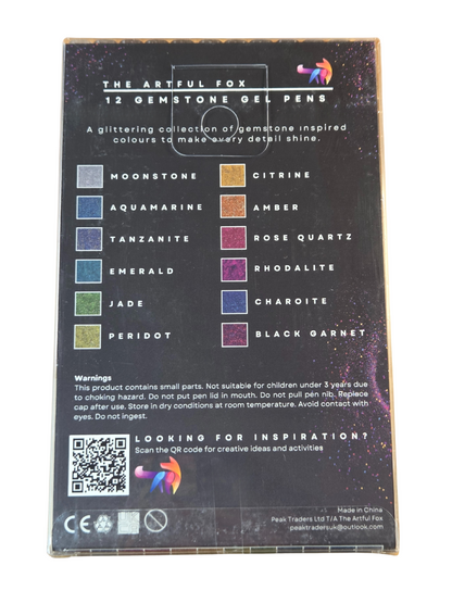 Back of a packaging for 'The Artful Fox' gemstone gel pens with color swatches and QR code.
