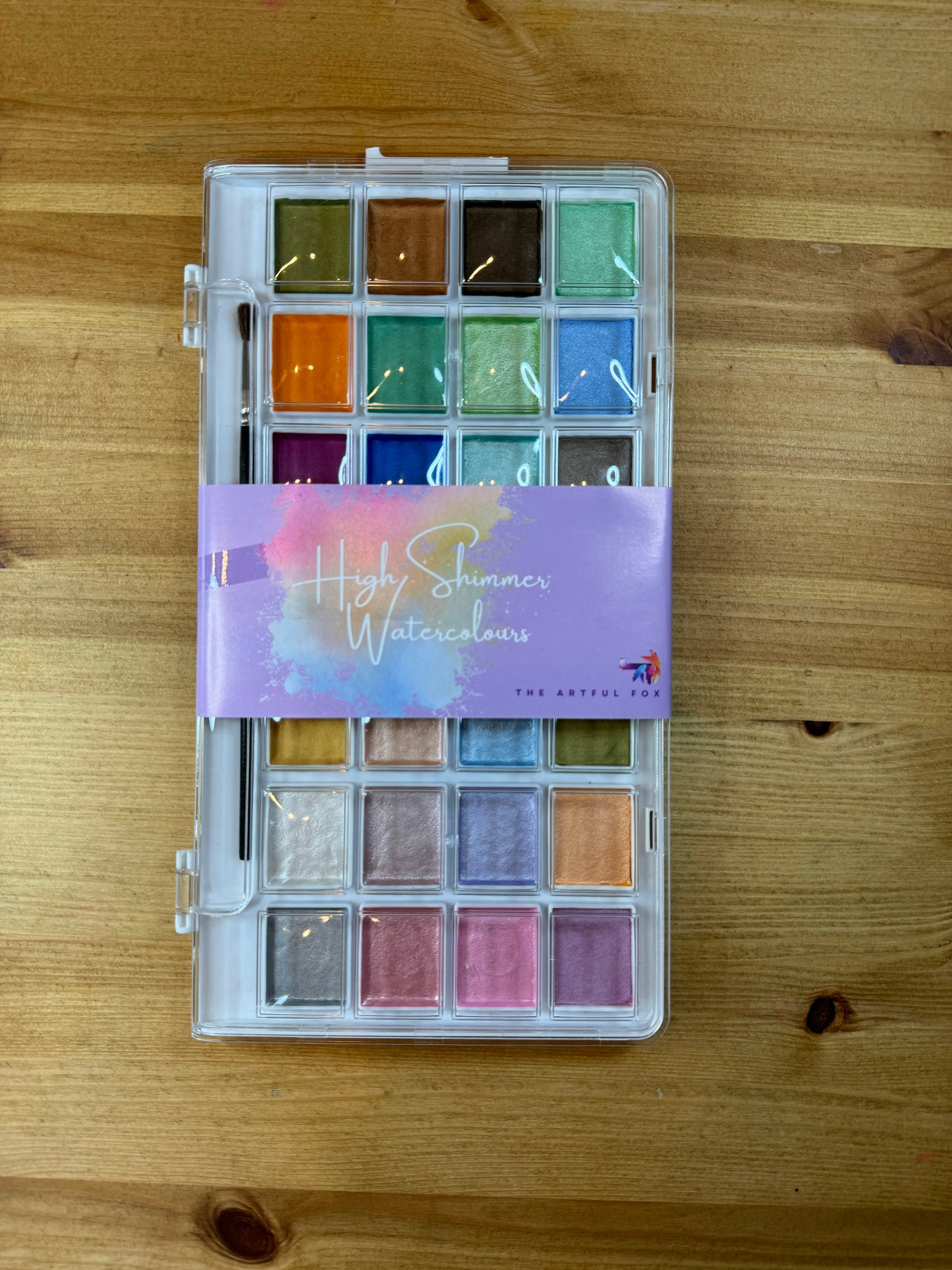 High Shimmer Watercolours by The Artful Fox. 28 pearlescent pastel paints for hobbyists and children, perfect for adding some sparkle to your artwork. Paintbrush included. Storage case with palette lid for mixing your perfect shimmering shade